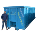 Jordan standing in front of a 40-yard dumpster for size comparison.